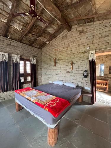 a bedroom with a large bed in a brick wall at Virasat homestay in Chanderi