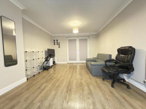 a living room with a couch and a chair at Bright Double Room in Wellingborough in Harrowden