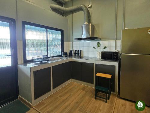 a kitchen with a sink and a refrigerator at Obahomu Vacation House for 4-8 pax, 5 min walk to Icon Siam in Bangkok