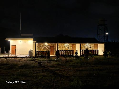 a house lit up at night with christmas lights at Eden Garden Bandipur Tiger Reserve in Gundlupet