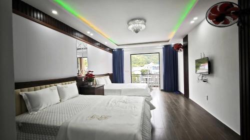 a bedroom with two beds and a rainbow on the ceiling at Hana Homestay KGR in Xuan Dam