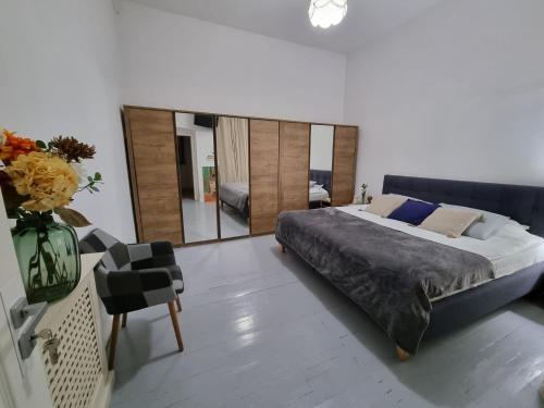 a bedroom with a large bed with a large mirror at Central House Craiova in Craiova