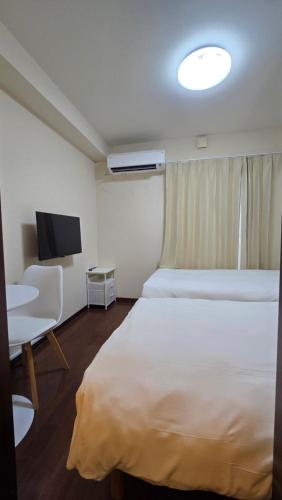 Кровать или кровати в номере メゾンドオーク 新大久保