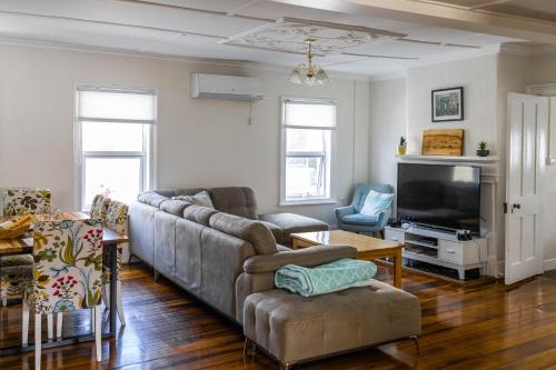 a living room with a couch and a tv at 128 Murray - Sassafras in Hobart