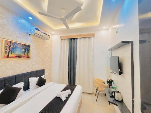 a hotel room with a bed and a tv at Hotel Devine Zirakpur Chandigarh in Zirakpur