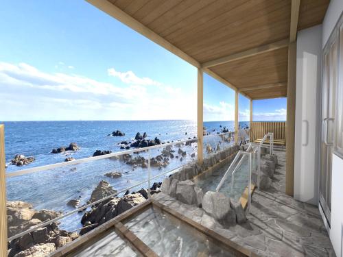 a view of the ocean from a house at MAX CUBE Inami Seafront in Inami