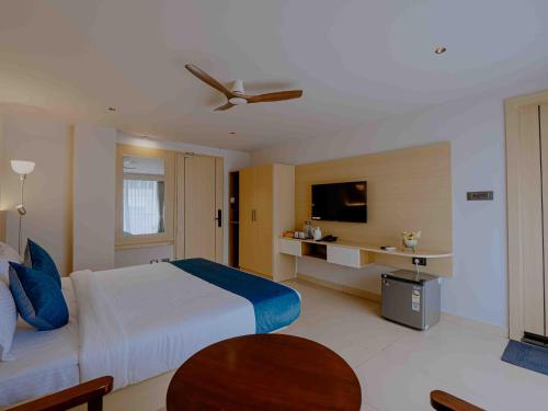 a hotel room with a bed and a television at Nine, Boutique hotel with luxury room stay, mysore in Mysore