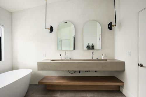 a bathroom with a large sink and two mirrors at The MYAH by Porter NEWLY REMODELED Enjoy the Pool Firepit Luxury in Phoenix