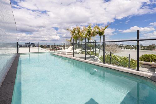 a swimming pool on the roof of a building at West End 2BR Gem with Rooftop Pool, Balcony & Parking in Brisbane