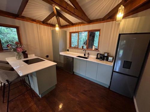 a kitchen with a sink and a refrigerator at The Cabin Luxury Safari Villa in Somerset