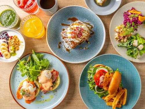 a table topped with plates of food on plates at Tokyu Stay Hakata in Fukuoka
