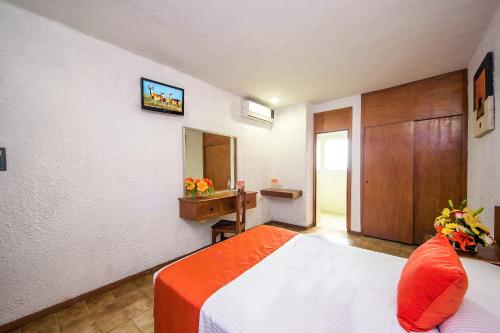 a hotel room with a bed and a mirror at Hotel Hacienda Vallarta - Playa Las Glorias in Puerto Vallarta