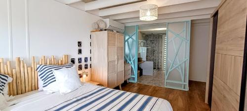 Postel nebo postele na pokoji v ubytování LA PALMERAIE - Locations de Villas et Appartements