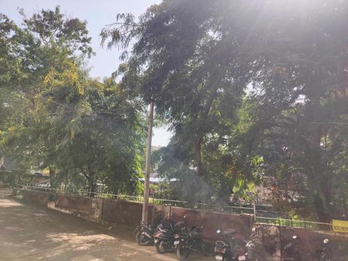a group of motorcycles parked next to a fence at Luxurious 2 BHK Apartment - Home away from Home ! in Udaipur