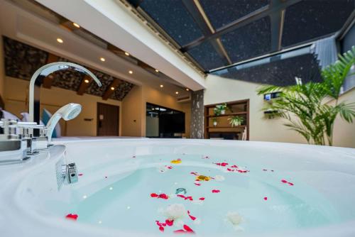 a bathroom with a bath tub with flowers in it at Shenshan Wild Escape （Lure Fishing and More） in Qingshan