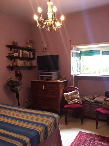 a bedroom with a bed and a tv and a window at Villa Nanda a 15 minuti da Roma piscina esclusiva , villa nella natura in Formello