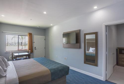 a hotel room with a bed and a mirror at Home Place Inn Spring I-45 North and 1960 in Westfield