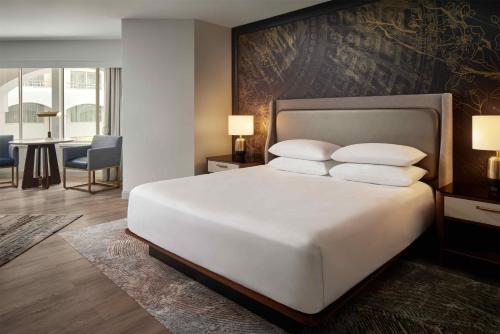 een slaapkamer met een groot wit bed met kussens bij Grand Hyatt Washington in Washington