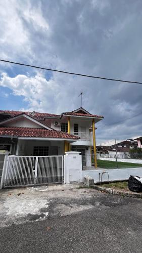 a white fence in front of a house at Anggun's palace in Pasir Gudang