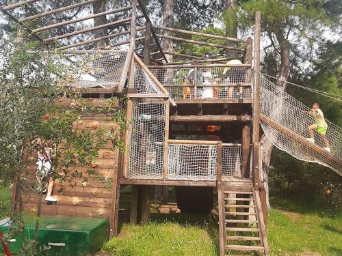 a tree house with people on the top of it at Cabañas Llano de los Conejos in Cañamares