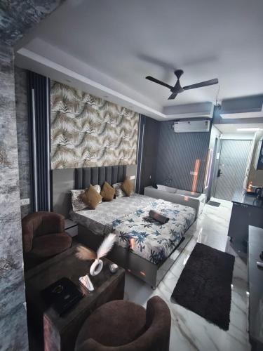 a living room with a bed and a couch at Suite with Private Jacuzzi in Ghaziabad
