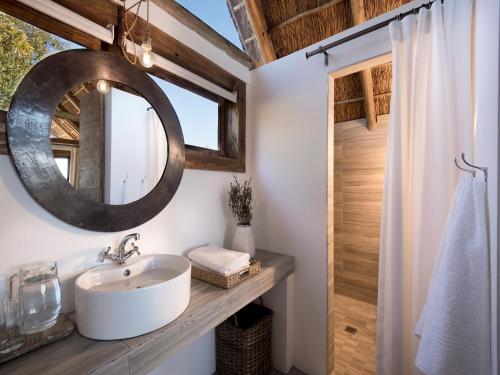 a bathroom with a sink and a mirror at Cradle Boutique Hotel in Lanseria