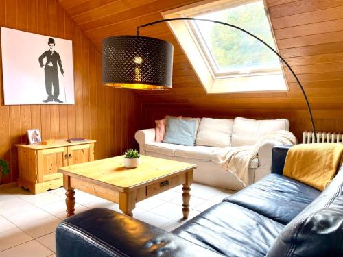 a living room with a couch and a table at Odw homes - Functional workers apartment in Weinheim