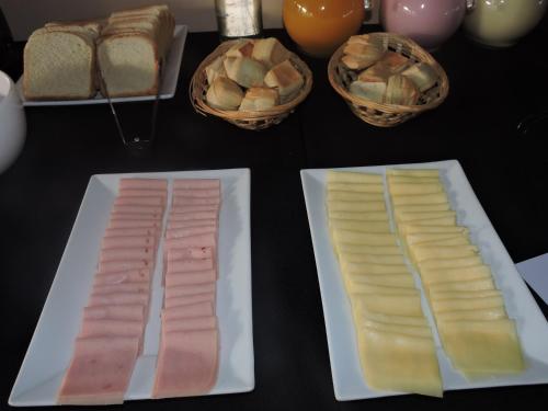 two plates of food on a table with bread at Rahuen Hotel/Restaurant in Carpintería