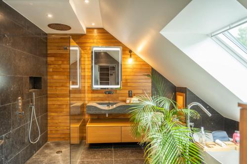 a bathroom with a sink and a mirror at La Maison Bas Lachamp - Luxuary Mountain Villa in Bellefosse