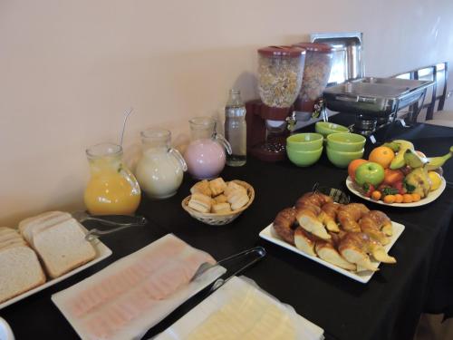 a table topped with plates of food and fruit at Rahuen Hotel/Restaurant in Carpintería