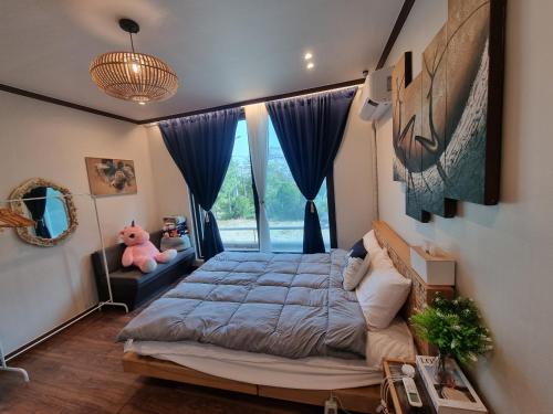 a bedroom with a bed and a window at 와바다펜션 속초고성 독채펜션12인 삼포해수욕장1분 바베큐불멍 in Goseong