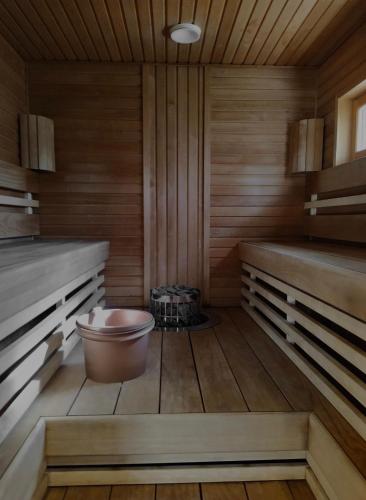 a sauna with a tub in a wooden room at Villa Pinja in Kalajoki