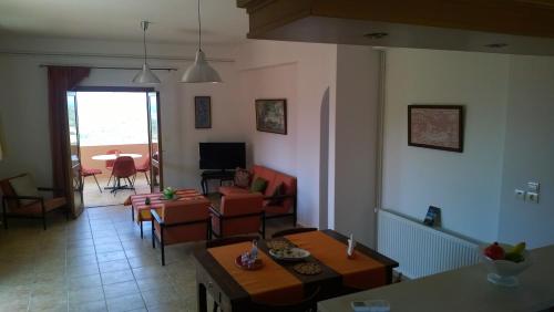 a living room with a couch and a table at House of Polymnia in Sissi