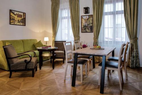 a living room with a table and chairs and a couch at Residence U Mecenáše in Prague