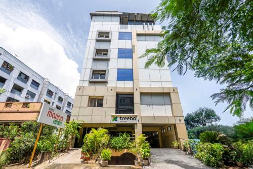 a tall building with plants in front of it at Treebo Marina Grand, Railway station in Visakhapatnam