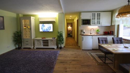 a living room with a kitchen and a dining room at Hotel Rebstock in Baden-Baden
