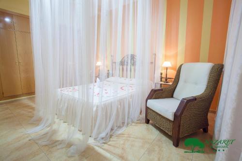 a room with a table and a chair and curtains at Complejo Turístico Rural Nazaret De Moguer in Moguer