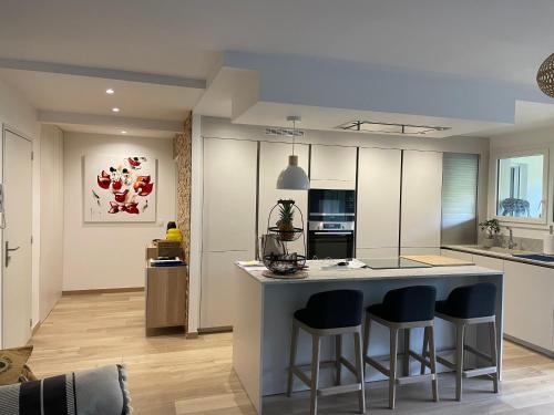 a kitchen with a island with bar stools at La Milady in Biarritz