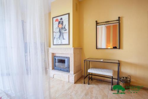 a living room with a fireplace and a mirror at Complejo Turístico Rural Nazaret De Moguer in Moguer