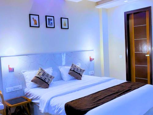 a bedroom with a large white bed with two pillows at Cassava Stay close to Visa Center in New Delhi