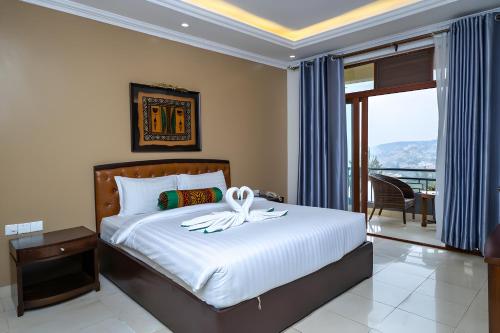 a bedroom with a bed with a flower on it at OMX Hotel Kimihurura in Kigali