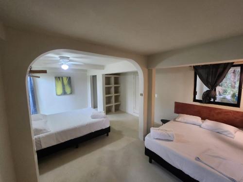 a bedroom with two beds and an arched doorway at MK BEACH Playa Del Carmen in Playa del Carmen