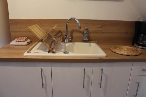 a kitchen sink with utensils on top of it at Escapade au Mont St Michel in Pleine-Fougères