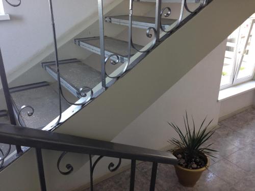 a staircase with metal shelves and a potted plant at U Fedora in Oleksandriya