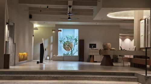 a lobby with a large window with a painting on the wall at Blanco Apartment Hotel in Bintulu