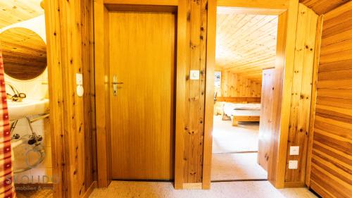 an open door to a room with wooden walls at Chalet Dorle, Riederalp Golmenegg in Riederalp