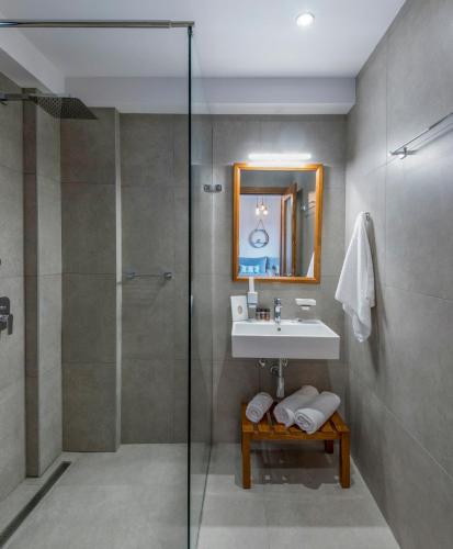 a bathroom with a sink and a shower at Villa Melia Luxury Suites in Ierissos