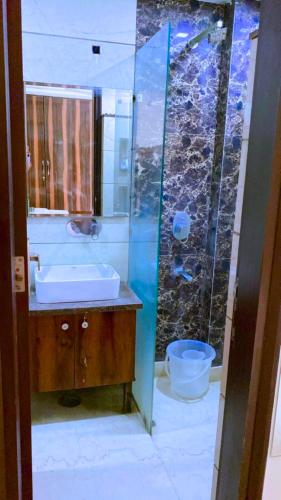 a bathroom with a sink and a shower at Cassava Stay - Near Rajendra Place & BLK Hospital in New Delhi