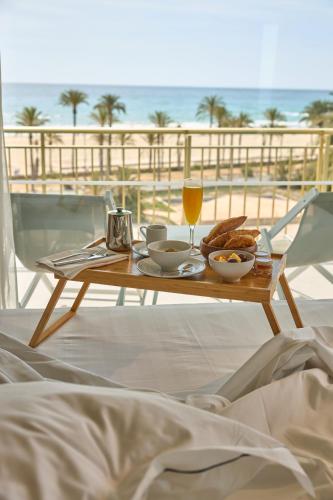 ein Tisch mit Essen und ein Glas Orangensaft in der Unterkunft Hotel Almirante in Alicante