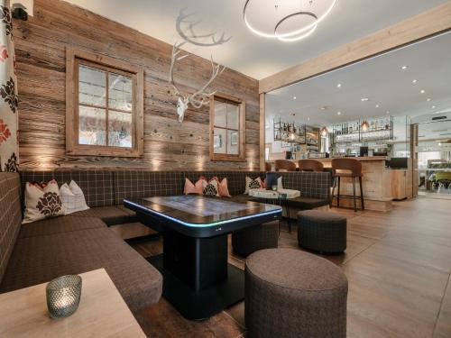 a restaurant with wooden walls and tables and chairs at Alpinhotel Monte Superior - Silvretta Card Premium Betrieb in Galtür